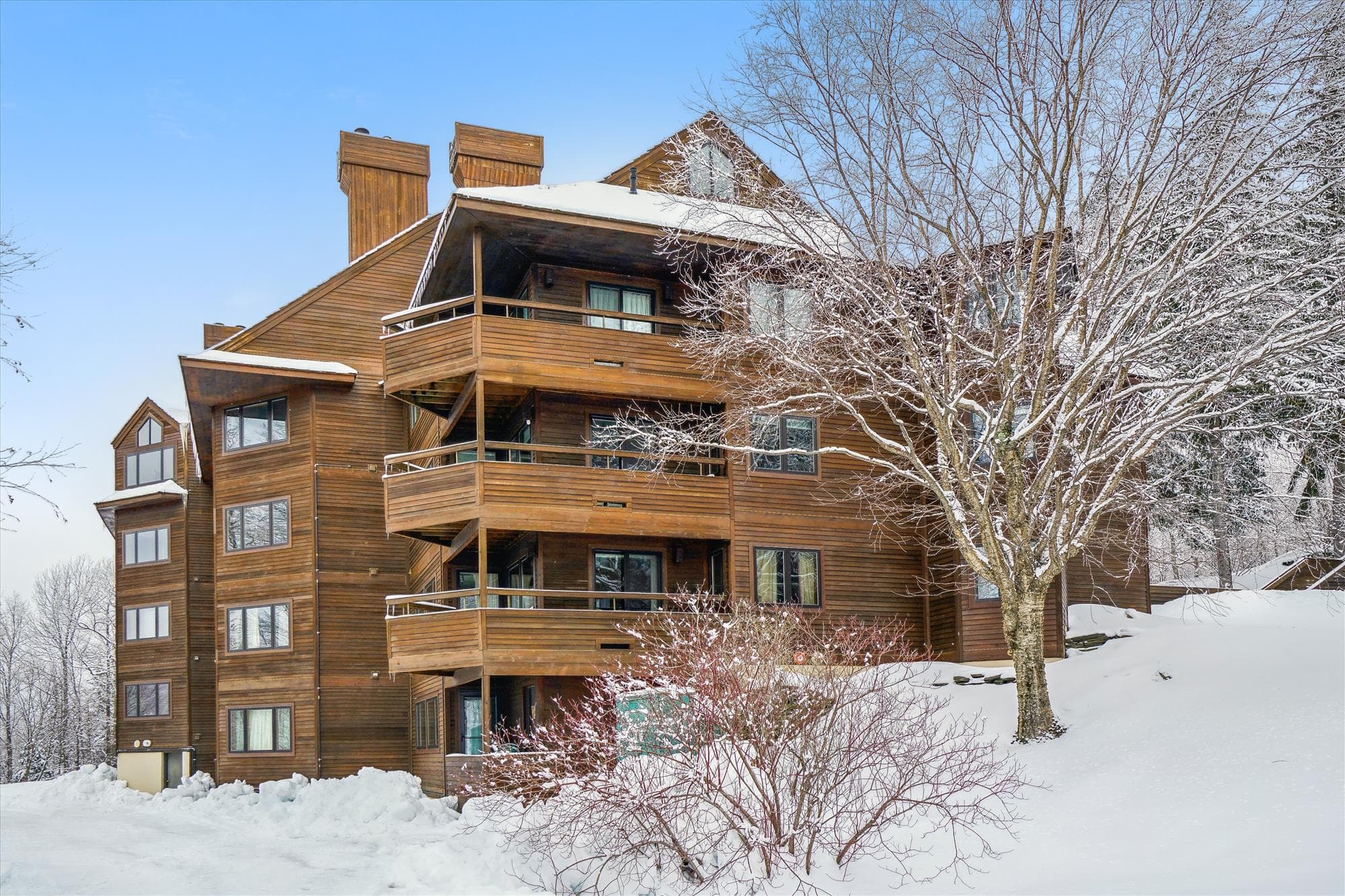 Alpine-style Highridge condominium building surrounded by beautiful winter scenery.