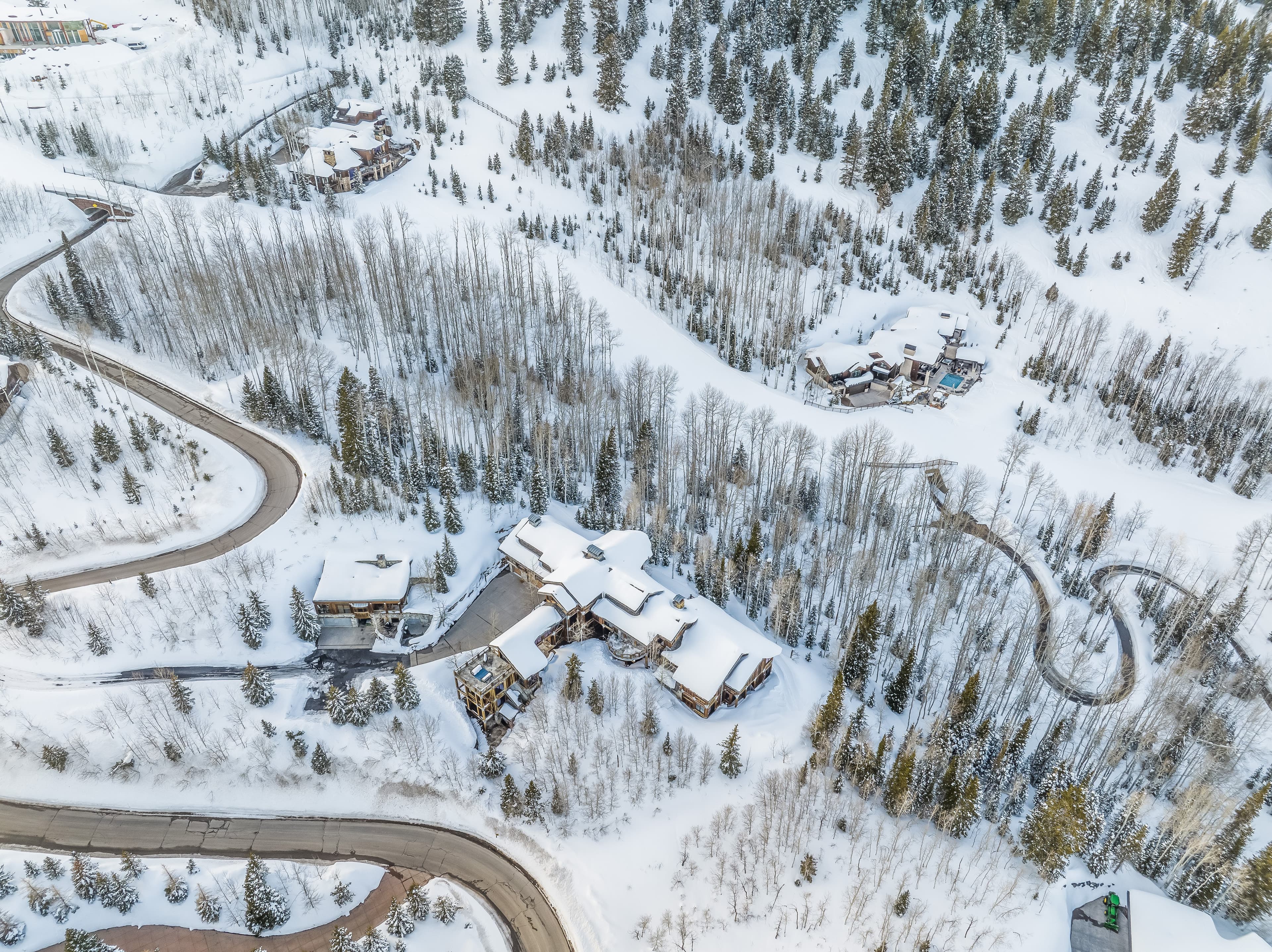 An aerial view of Talus Ridge, showing winding roads around it tracing their way through the snow.