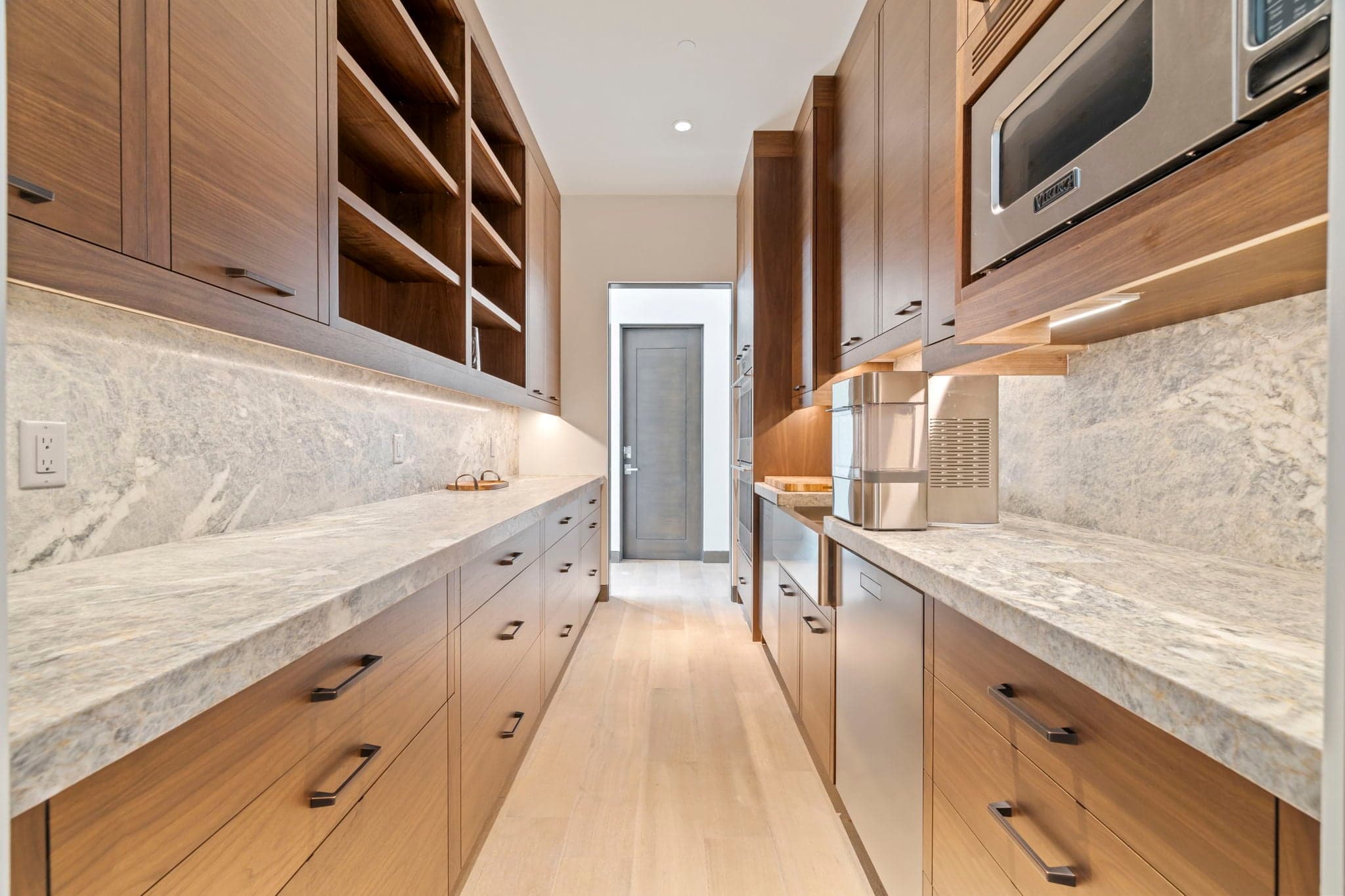 The pantry area with shelving and cabinets.
